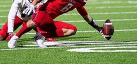 American footballer catching American football