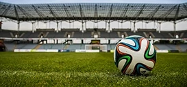 Football on pitch in empty stadium