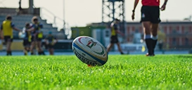 Rugby ball close up on pitch in rugby match